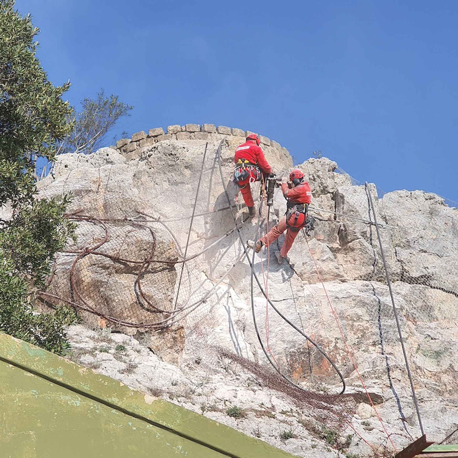 Martina Franca (TA), Due rocciatori applicano un ancoraggio lungo la parete rocciosa